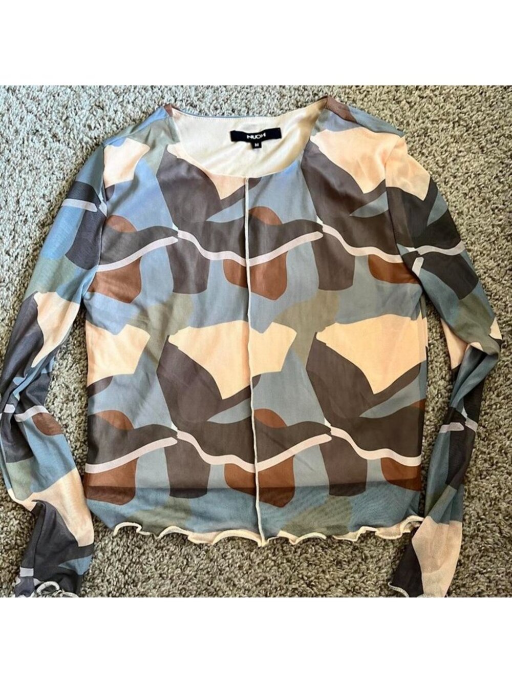 Camouflage print blouse with ruffled hem and long sleeves